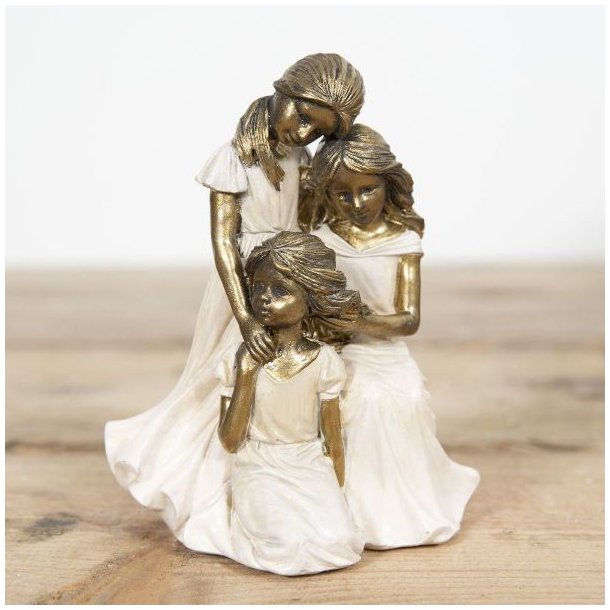 La Vida figur af tre piger i hvide kjoler med gul, der st�r sammen.