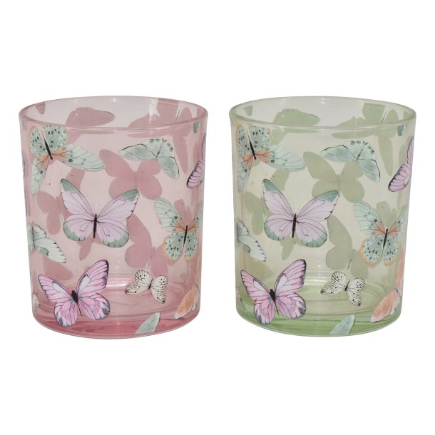 Fritlagt billede af to store fyrfadsstager i glas i farverne gr�n og rosa med hvidt sommerfugleprint.