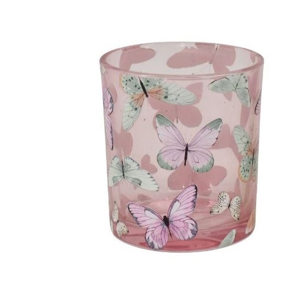 Fritlagt billede af den lille model af fyrfadsstagen i rosa glas med hvidt sommerfugleprint.