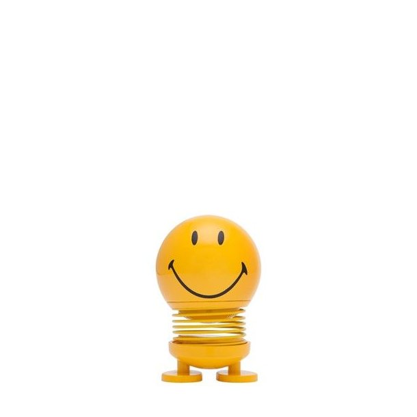 baby-smiley-yellow En klassisk lille gul Hoptimist Smiley med et stort smil og en synlig metalfjeder, fritlagt p� en ren hvid baggrund.