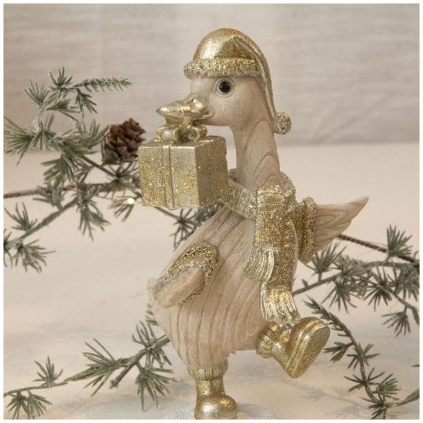 dekorationsand med guldfarvet nissehue og en gylden julegave