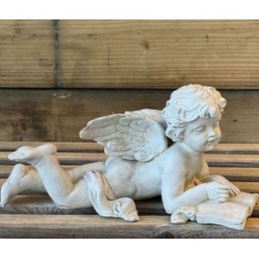 hvid englefigur i polyresin, der ligger ned og l�ser i en opsl�et bog