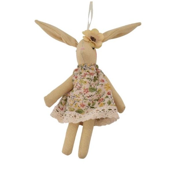 Fritlagt figur af en siddende p�skehare i en lys m�nstret stofkjole.