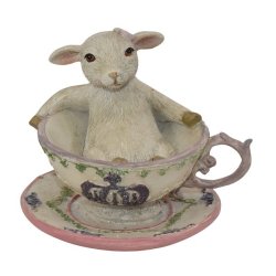 Fritlagt p�skefigur af et hvidt lam i en dekoreret kop med krone-motiv p� hvid baggrund.
