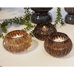retro-fyrfadsstager-brune-glas-tre-nuancer Tre m�nstrede retro fyrfadsstager i brunt, gennemsigtigt glas st�ende samlet p� et lyst bord. Nuancerne sp�nder harmonisk fra en m�rk chokoladebrun over en varm mellembrun til en lys, gyldenbrun variant. St�rrelse: H6 / D10,5 cm.
